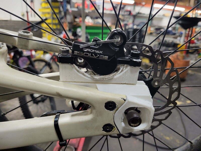 White printed prototype adapter fitted to the bike frame