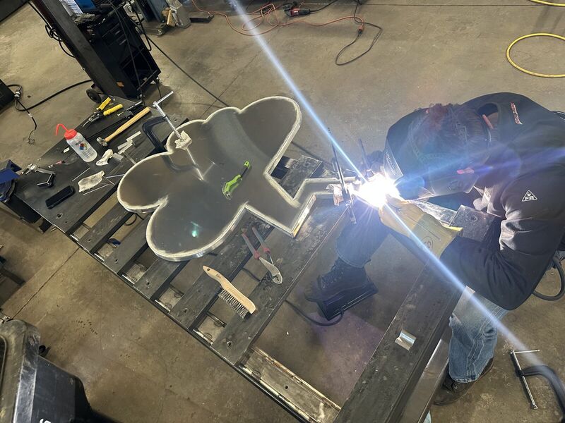 TIG welding the edge of a cloud with a lightning bolt