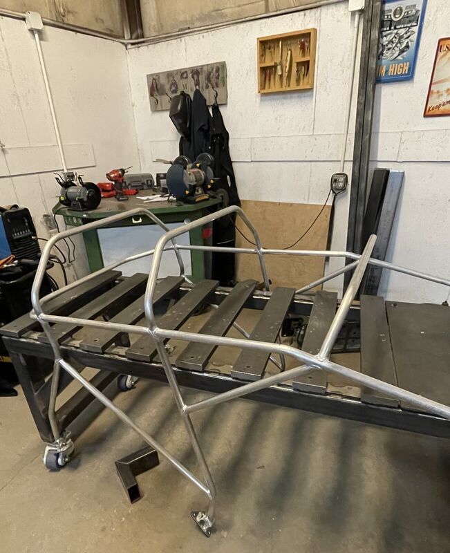 The bare welded aluminum frame on the shop bench